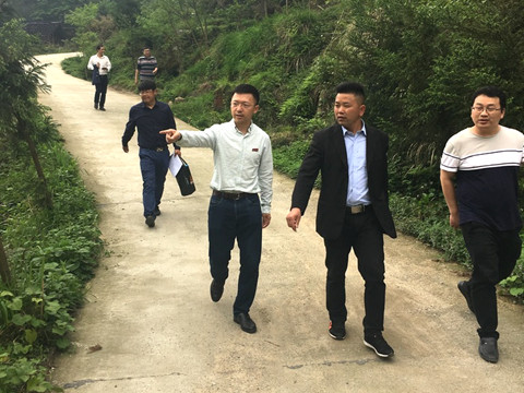 A group of people walking on a pathDescription automatically generated